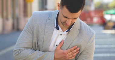 What causes breast pain in men